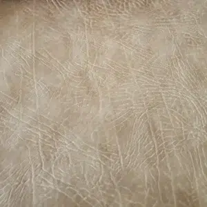 Distressed leather King Ranch in Sandstone Tan with vintage grain texture for automotive, marine, and cigar lounge interiors