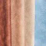 Distressed leather King Ranch upholstery vinyl in brown, saddle, tan, beige, and blue color collection