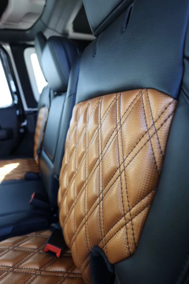 Carbon fiber vinyl upholstery custom seat installed in Jeep Bronco featuring diagonal weave emboss and diamond stitch pattern