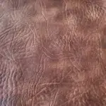Distressed leather King Ranch upholstery vinyl in Light Tobacco Brown with rugged grain texture