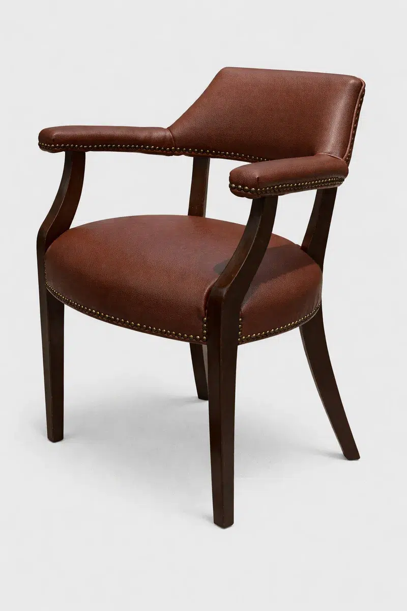 Fine pebble grain marine vinyl and faux leather upholstery material in burgundy shown on a cruise ship armchair reupholstered by the OEM upholsterer, part of the Bradley Collection.
