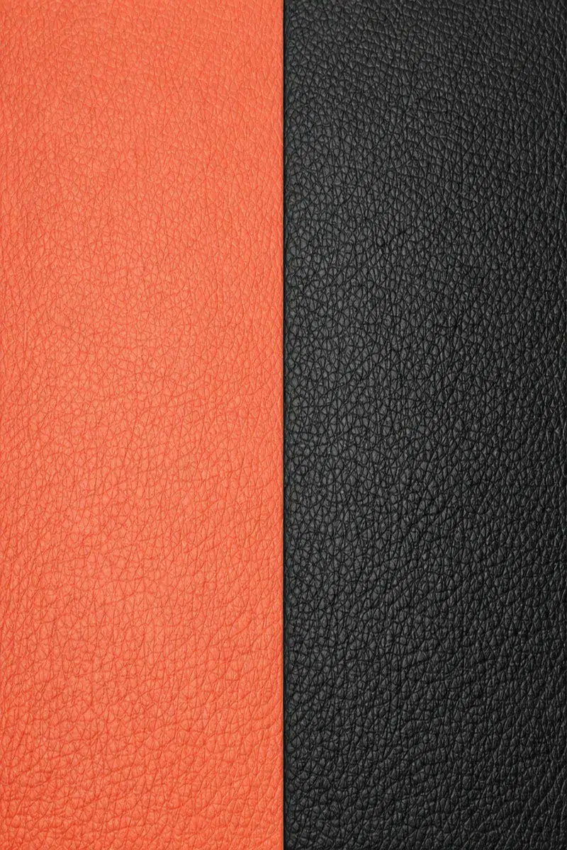 Soft grain pebble faux leather upholstery texture with rounded irregular pebbles in marine terracotta