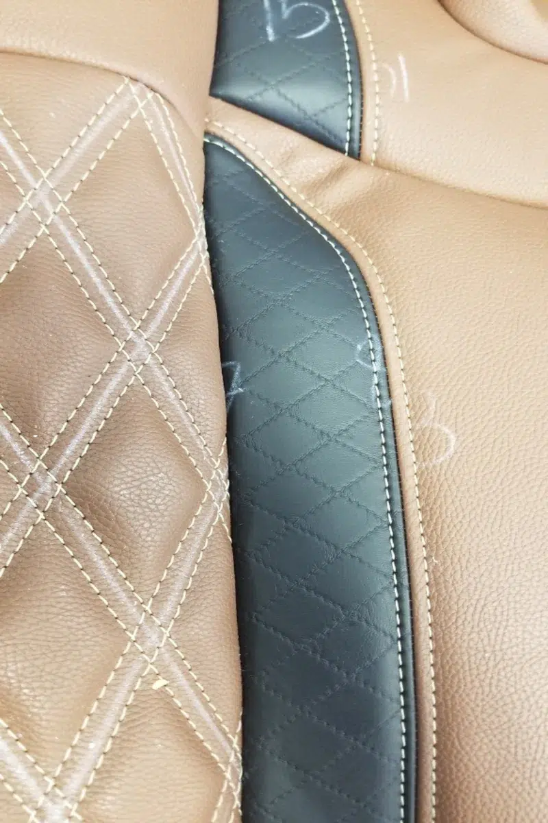 Black diamond quilted seat insert accent upholstery with custom stitching detail on a custom automotive seat using Joya Mer