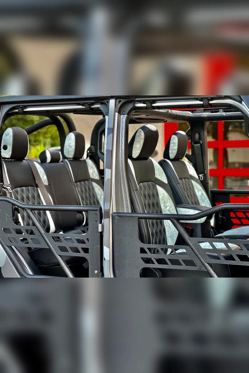 Full interior of a custom off-road vehicle with Arctic Stealth camo accents and black diamond quilted faux leather seats.