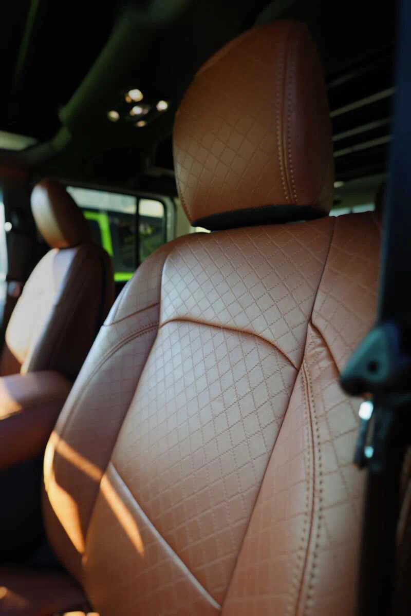 Diamond quilted embossed seat upholstery in Morocco brown installed on a custom Jeep interior using Joya Mer