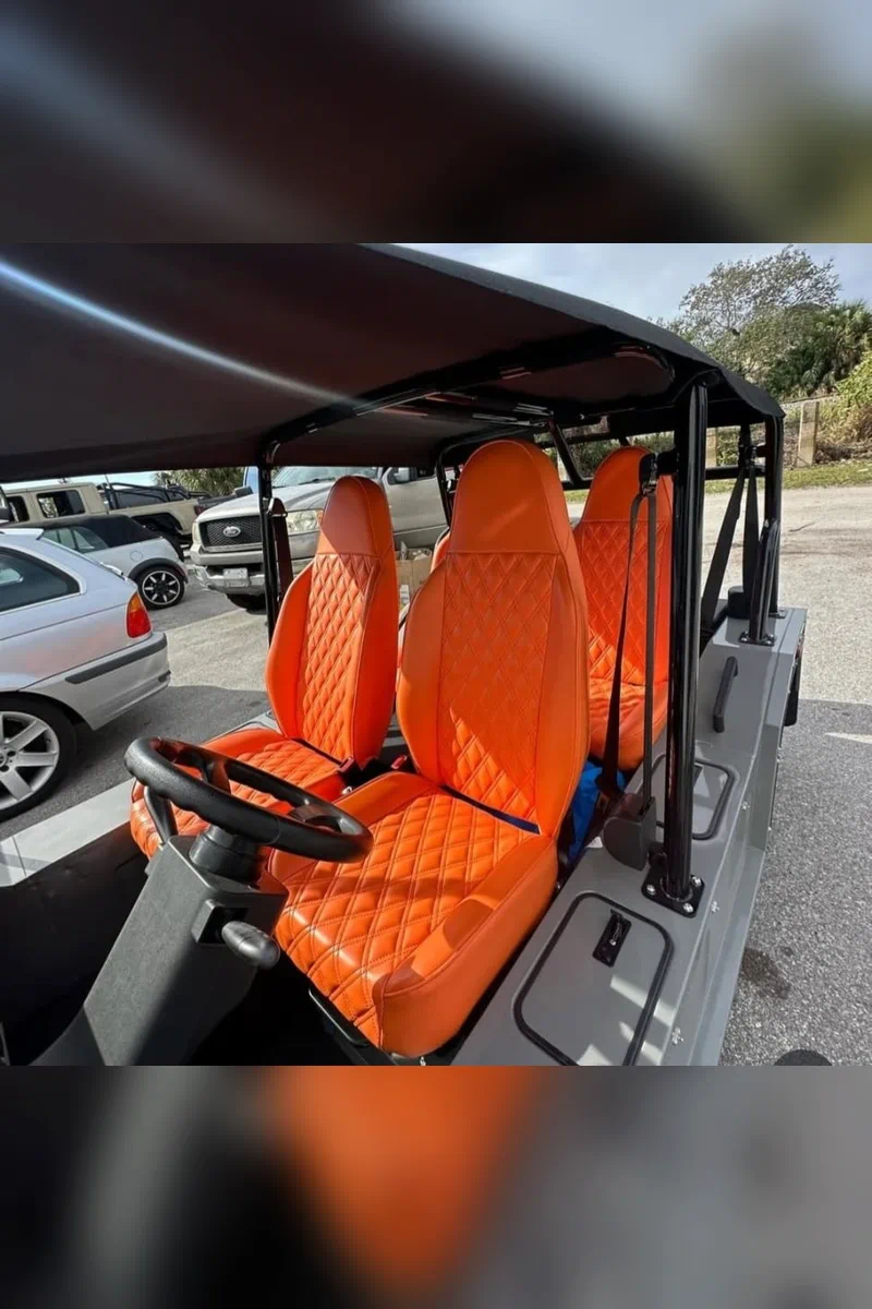 Papaya Orange Montero large pebble grain upholstery installed on custom golf cart seats.