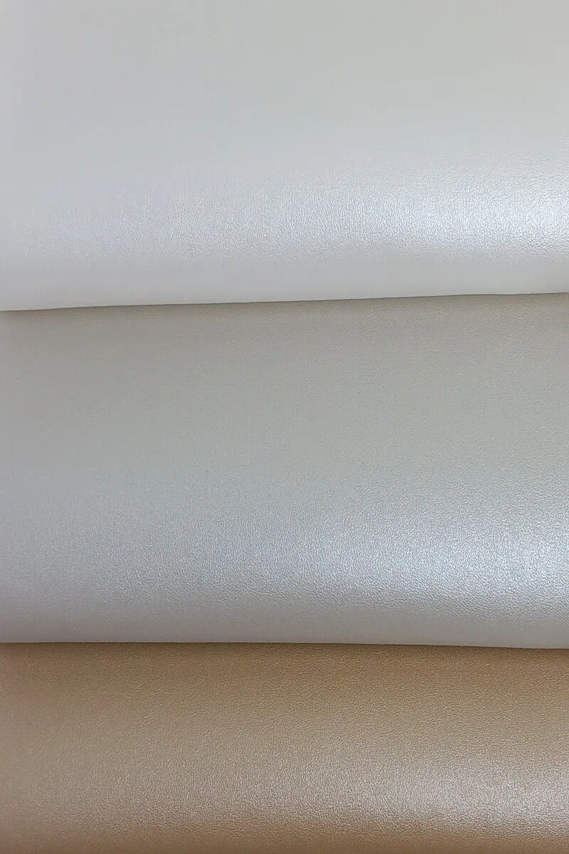 Pearl smooth vinyl texture from the Cubagua collection shown in white, pure pearl white, and champagne pearlized gold