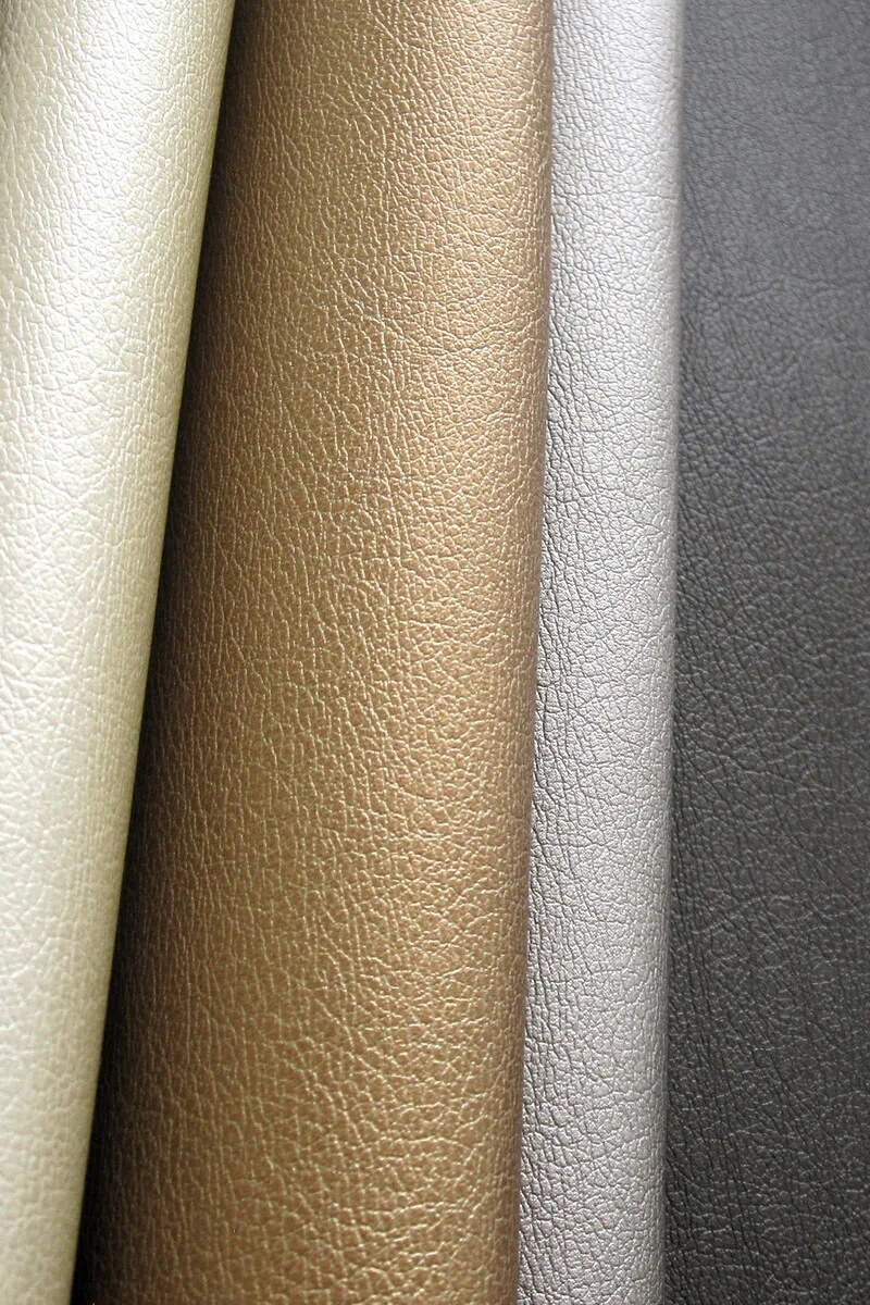 Pearlescent fine pebble grain texture from the Lorella collection shown in light neutral, champagne gold, silver gray, and charcoal tones