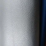 Pearlized pebbled leather texture hero image showing Montello Mer with medium pebble grain and luminous shimmer for upholstery