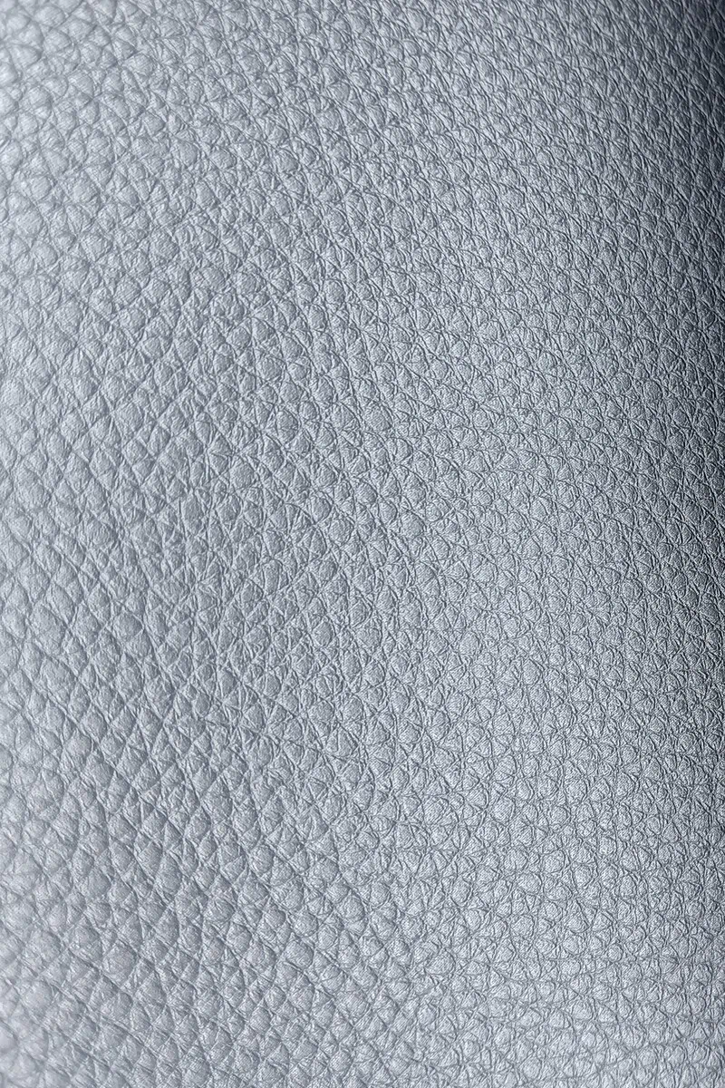 Close-up of pearlized pebbled leather texture in Montello Mer finish for upholstery.
