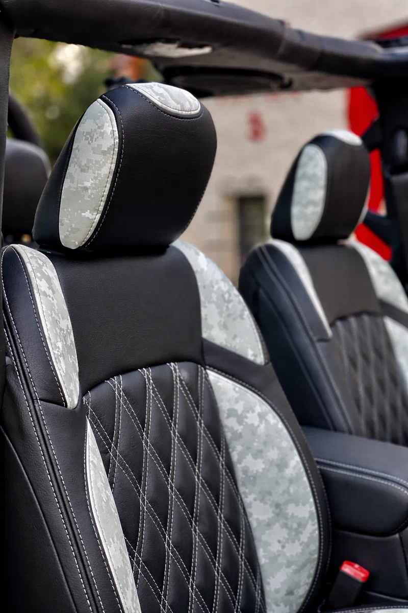 Custom off-road vehicle seats featuring Arctic White digital camo accents and black diamond quilted faux leather upholstery.