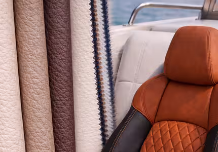 Performance faux leather and marine vinyl upholstery fabric with custom diamond stitching.