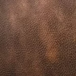 Close up texture detail of two-tone pebble leather fabric in Antique Brown