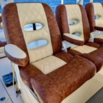Custom luxury yacht captain chairs upholstered in two-tone cream and textured King Ranch marine vinyl.