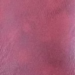 Close-up of the Nautic distressed leather texture fabric in the Oxblood Red variation showing rich visual movement